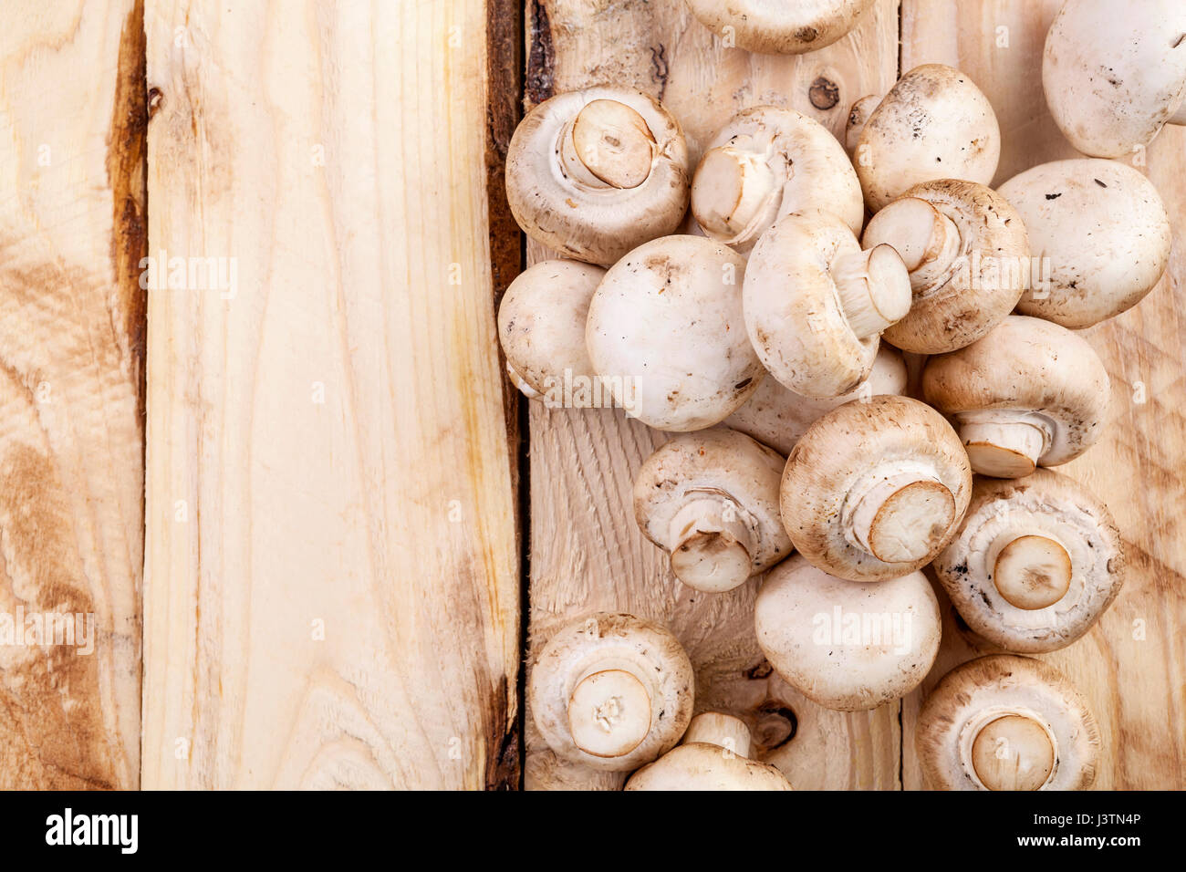 Mushrooms champignon on wooden table. Top view. Copy space. Stock Photo