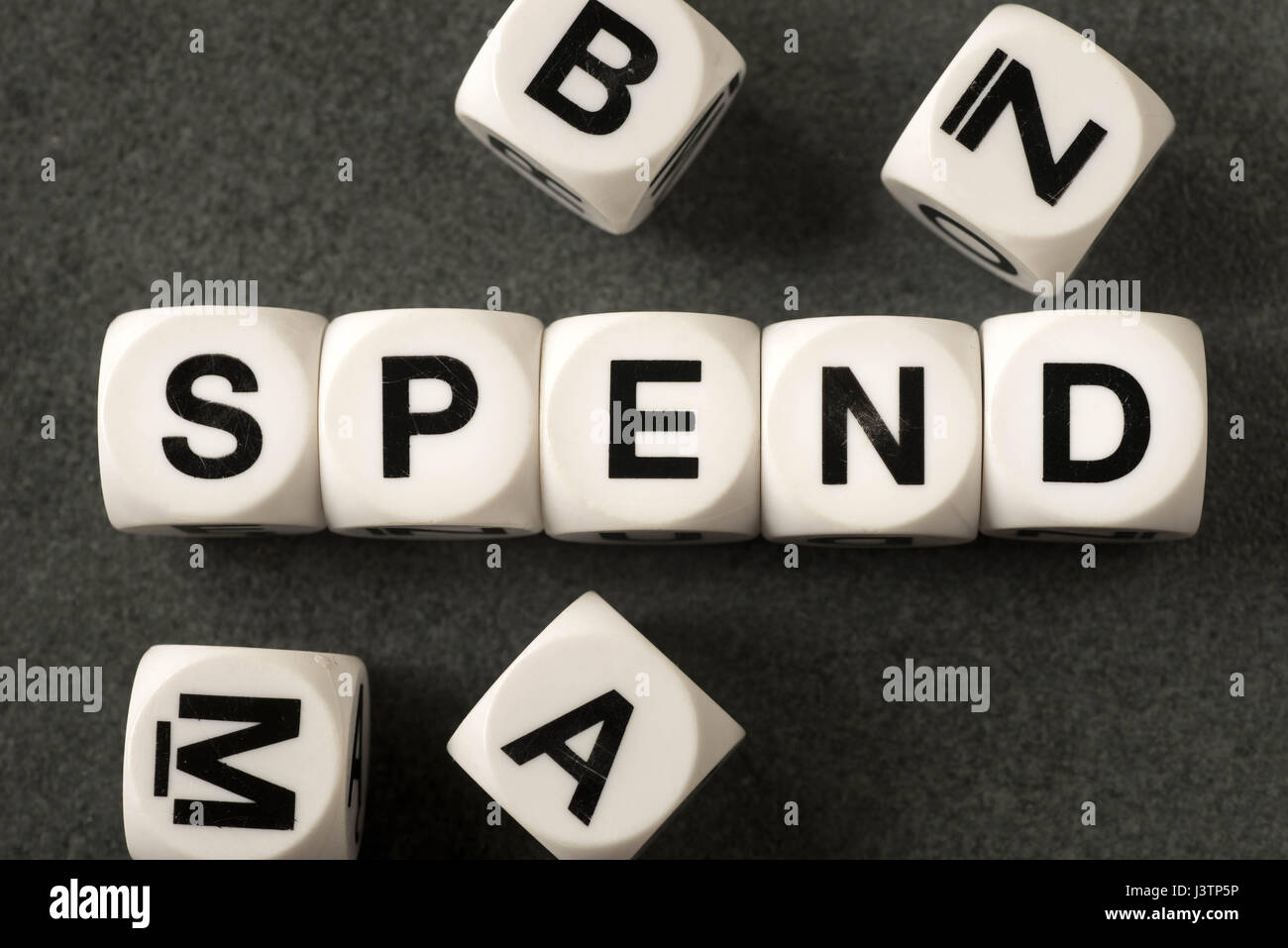 word spend on white toy cubes Stock Photo