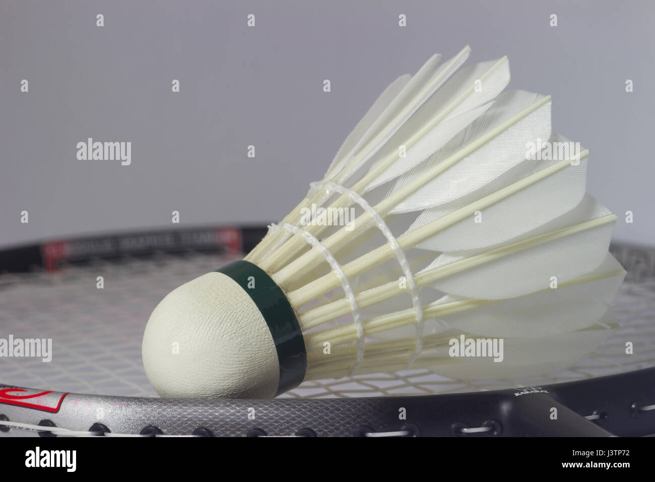 Feather Badminton shuttlecock  on racket Stock Photo