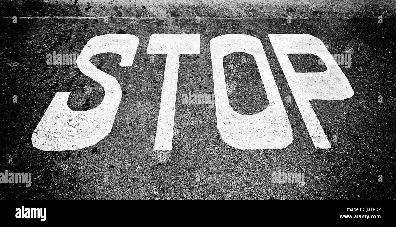 Stop sign on asphalt, detail of a traffic signal, security and prohibition Stock Photo