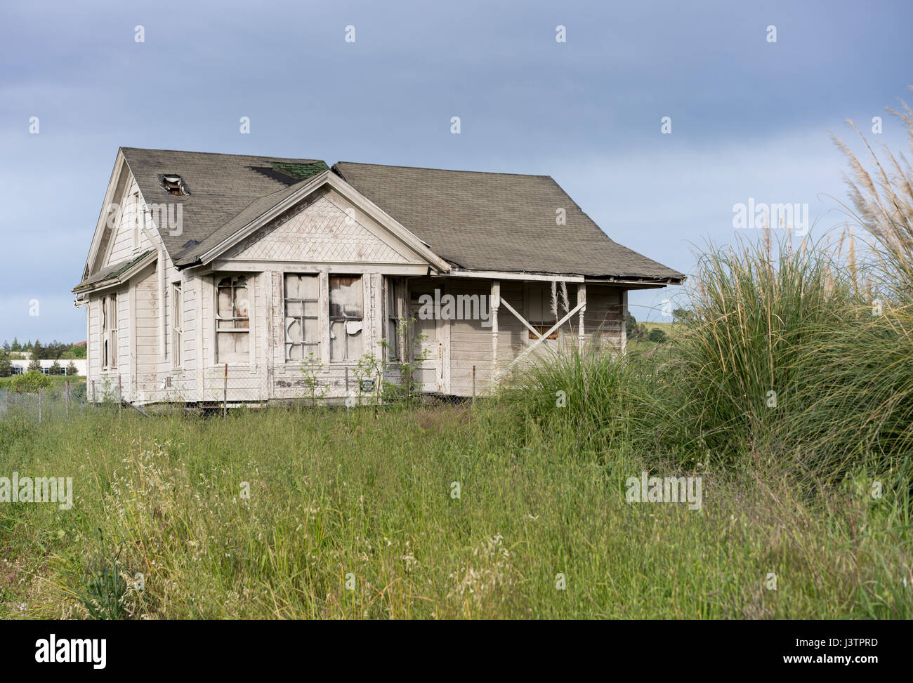 Abandoned single family home with wooden siding as fixer upper property Stock Photo