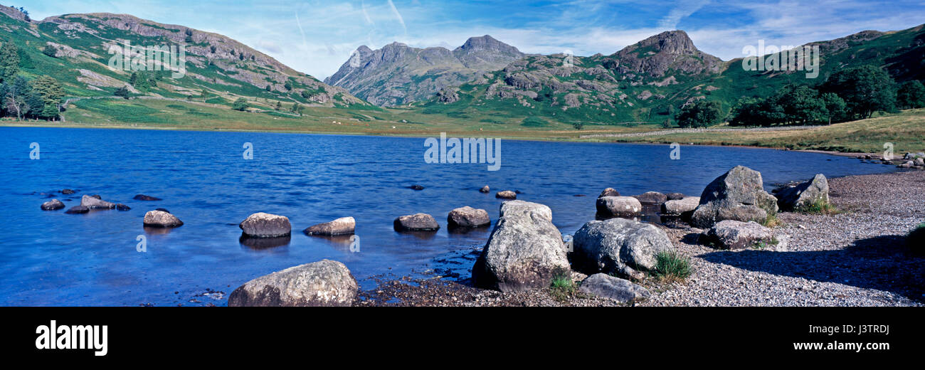 A silent morning at the iconic Blea Tarn in the Lake District Cumbria with the hills and Langdale Pikes in the background Stock Photo
