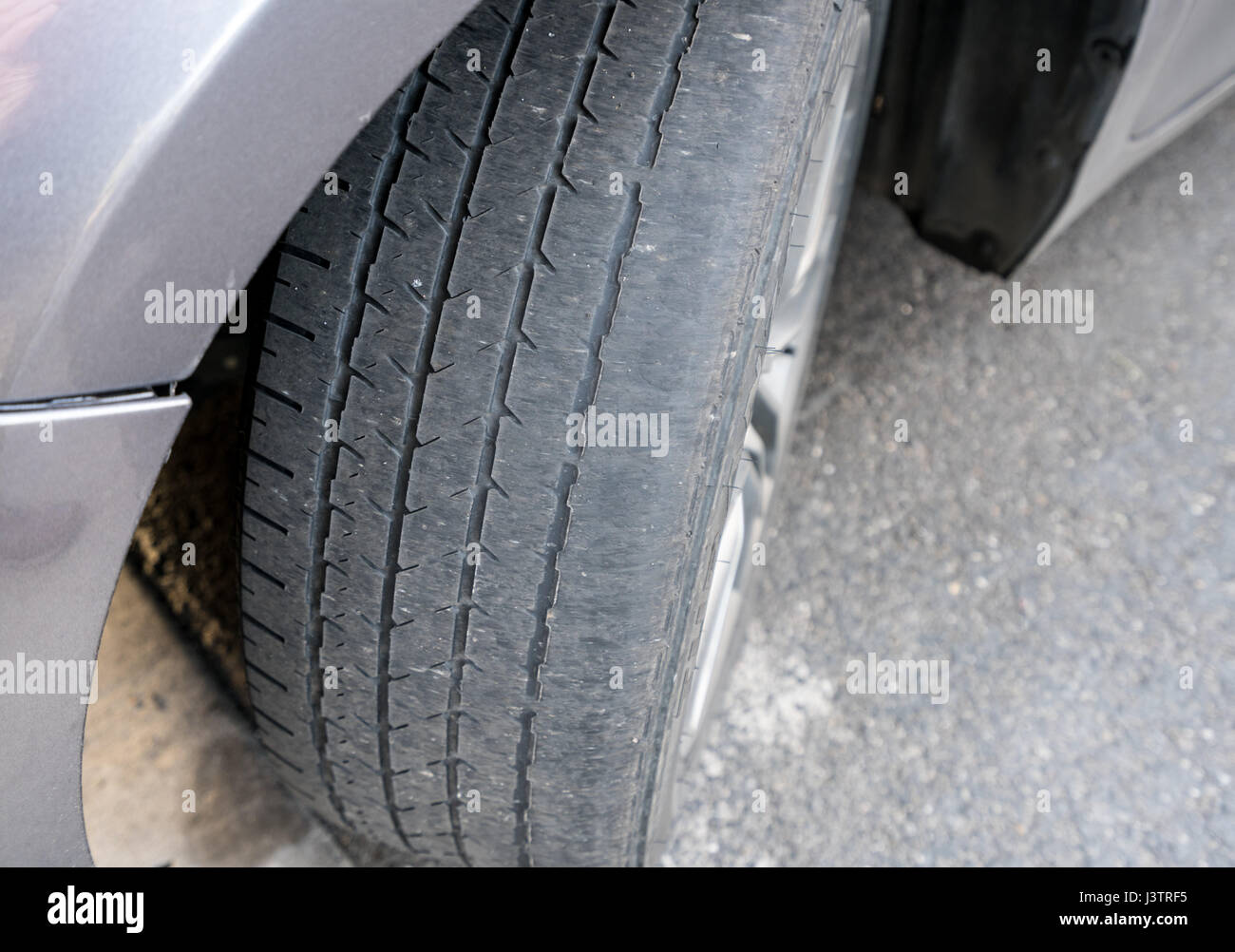 Car with worn bald tire unsafe hires stock photography and images Alamy