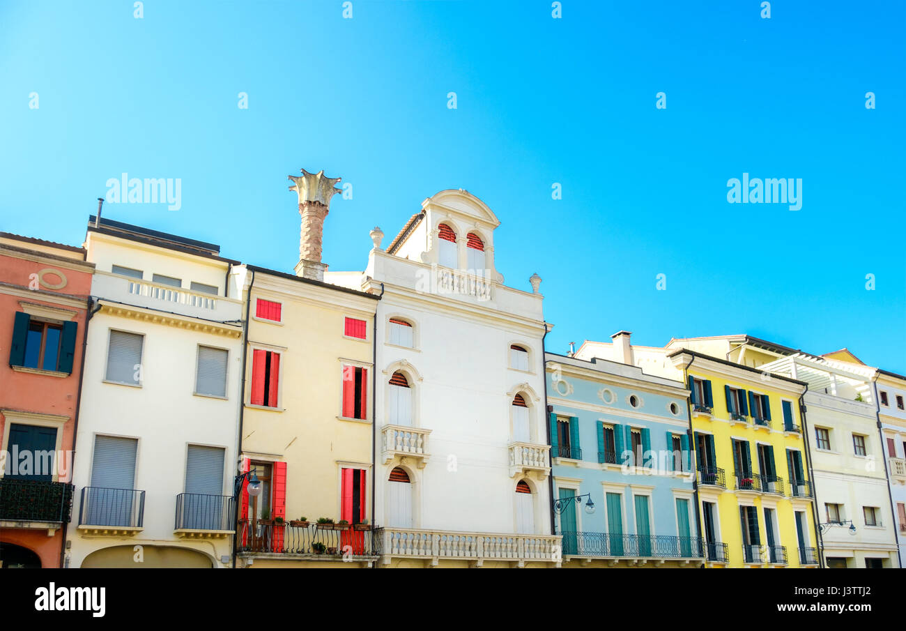 row of Italian residential buildings colorful blue sky Stock Photo