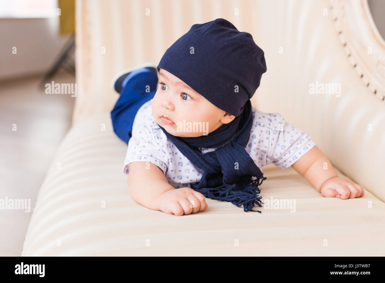 Portrait of cute baby boy wearing blue hat Stock Photo - Alamy