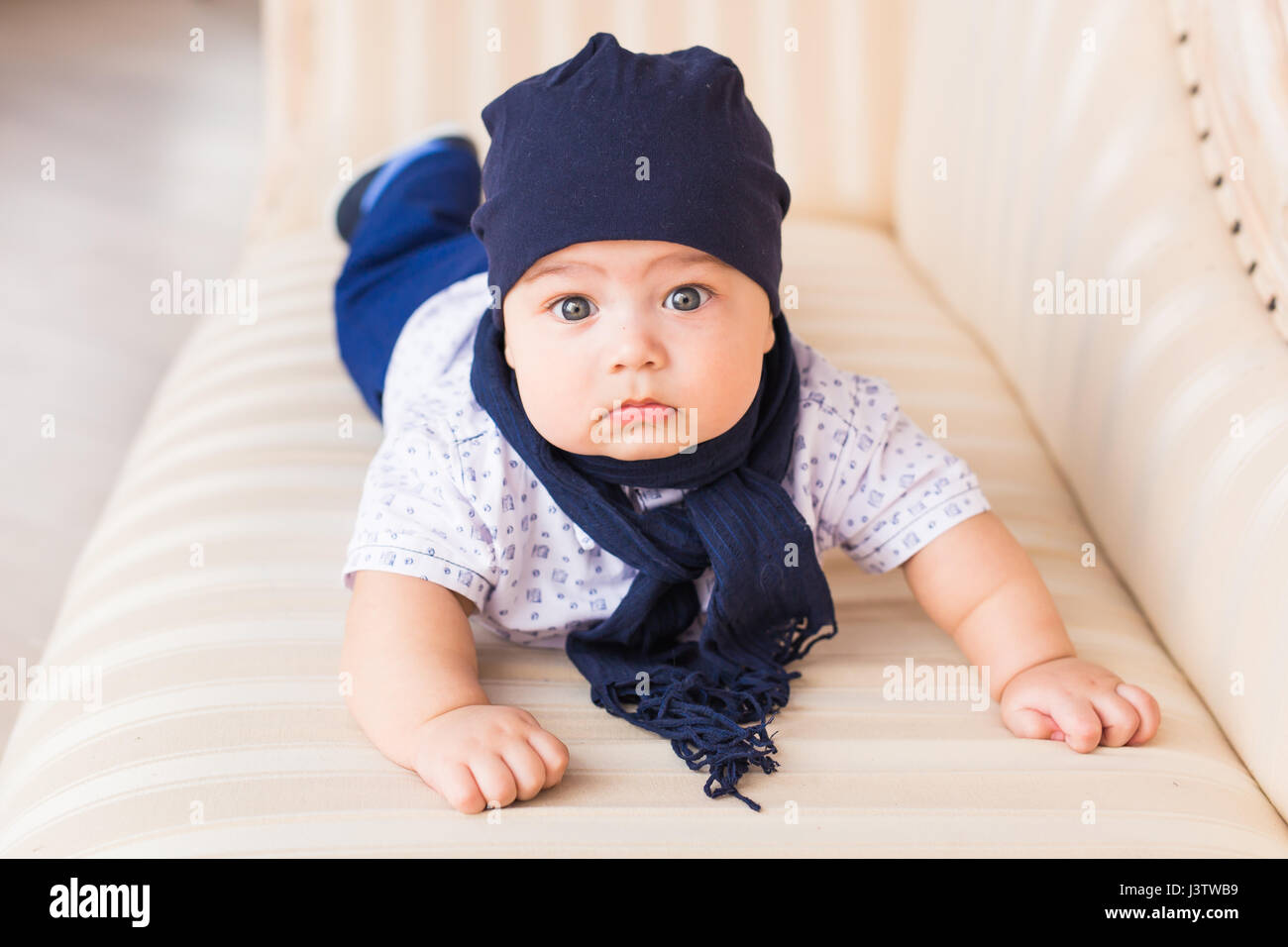 Close up portrait of cute baby boy wearing blue hat Stock Photo - Alamy