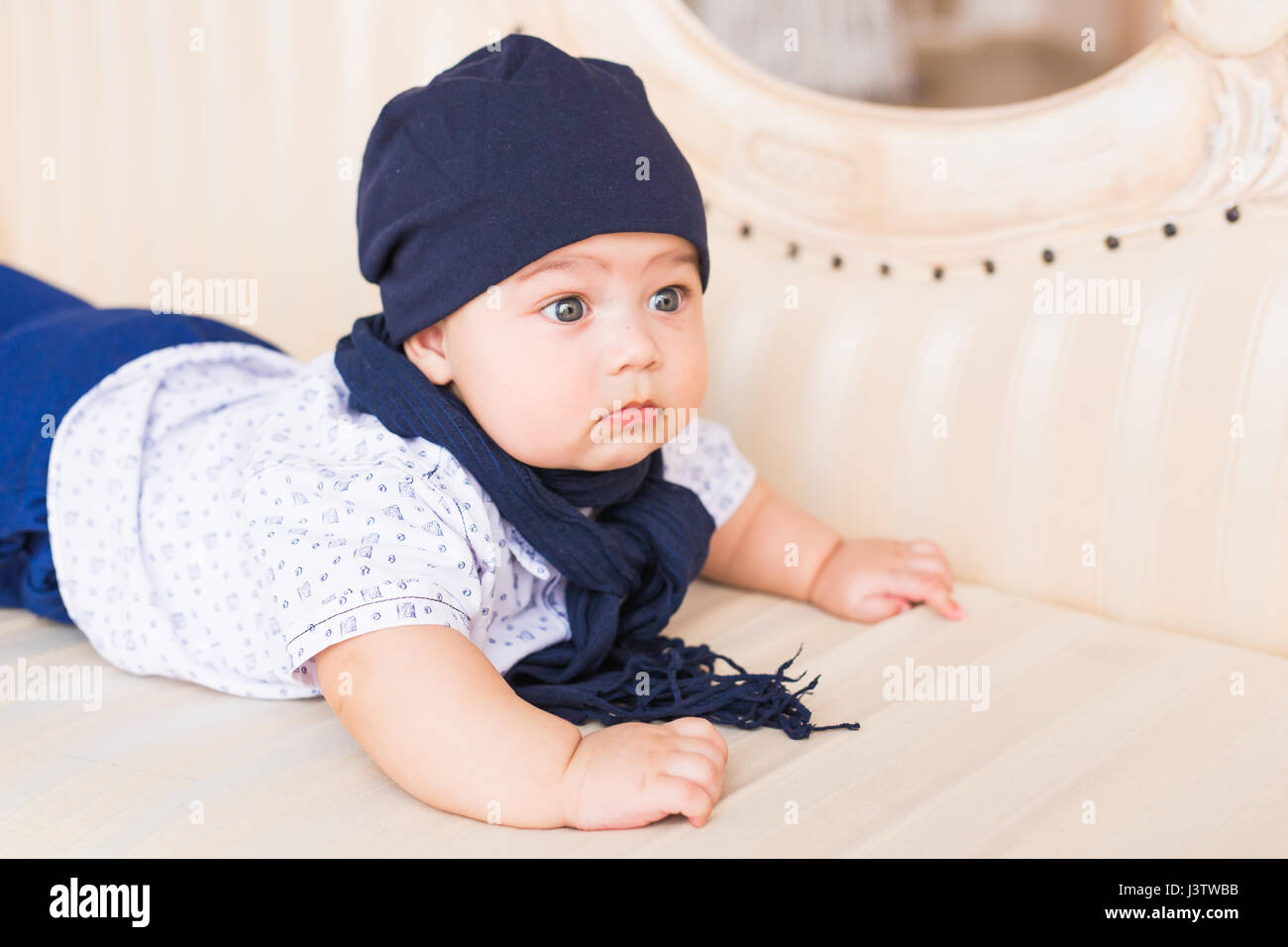 Close up portrait of cute baby boy wearing blue hat Stock Photo - Alamy