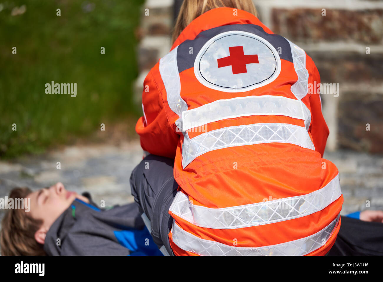 Professional paramedic giving unconscious young man first aid Stock