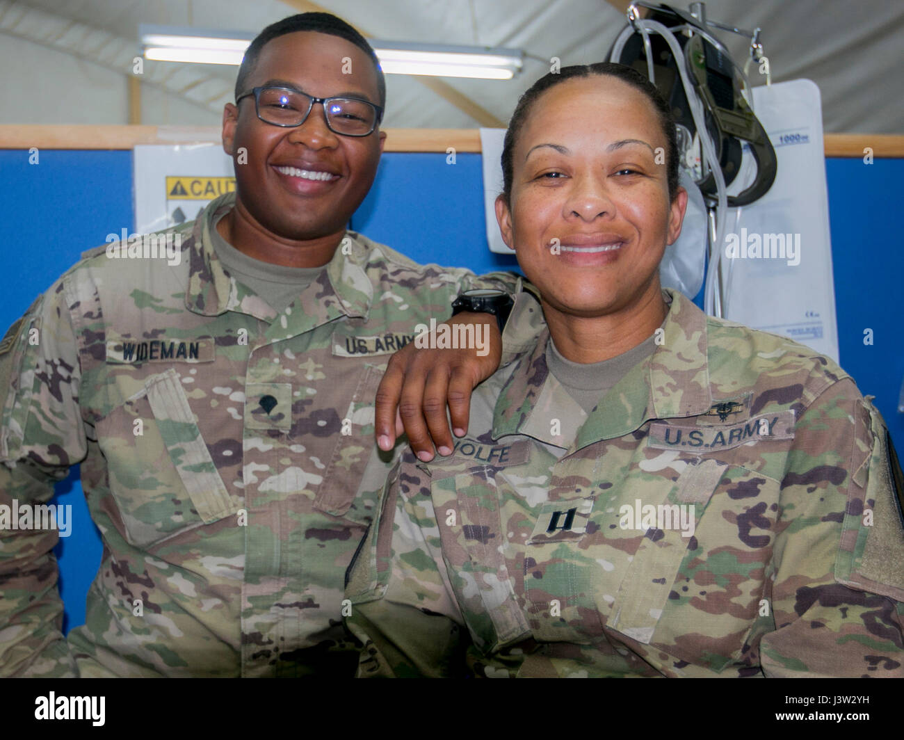 Capt. Andrea Wolfe, senior brigade physician assistant, and her son Spc. Kameron Wideman, a behavioral health technician, both assigned to the Brigade Support Medical Company, 215th Brigade Support Battalion, 3rd Armored Brigade Combat Team, 1st Cavalry Division, are deployed for nine months to Camp Buehring, Kuwait. 'We are passionate about the military,' Wolfe said. 'This is our Army.' (U.S. Army photo by Staff Sgt. Leah R. Kilpatrick, 3rd Armored Brigade Combat Team Public Affairs Office, 1st Cavalry Division (released) Stock Photo