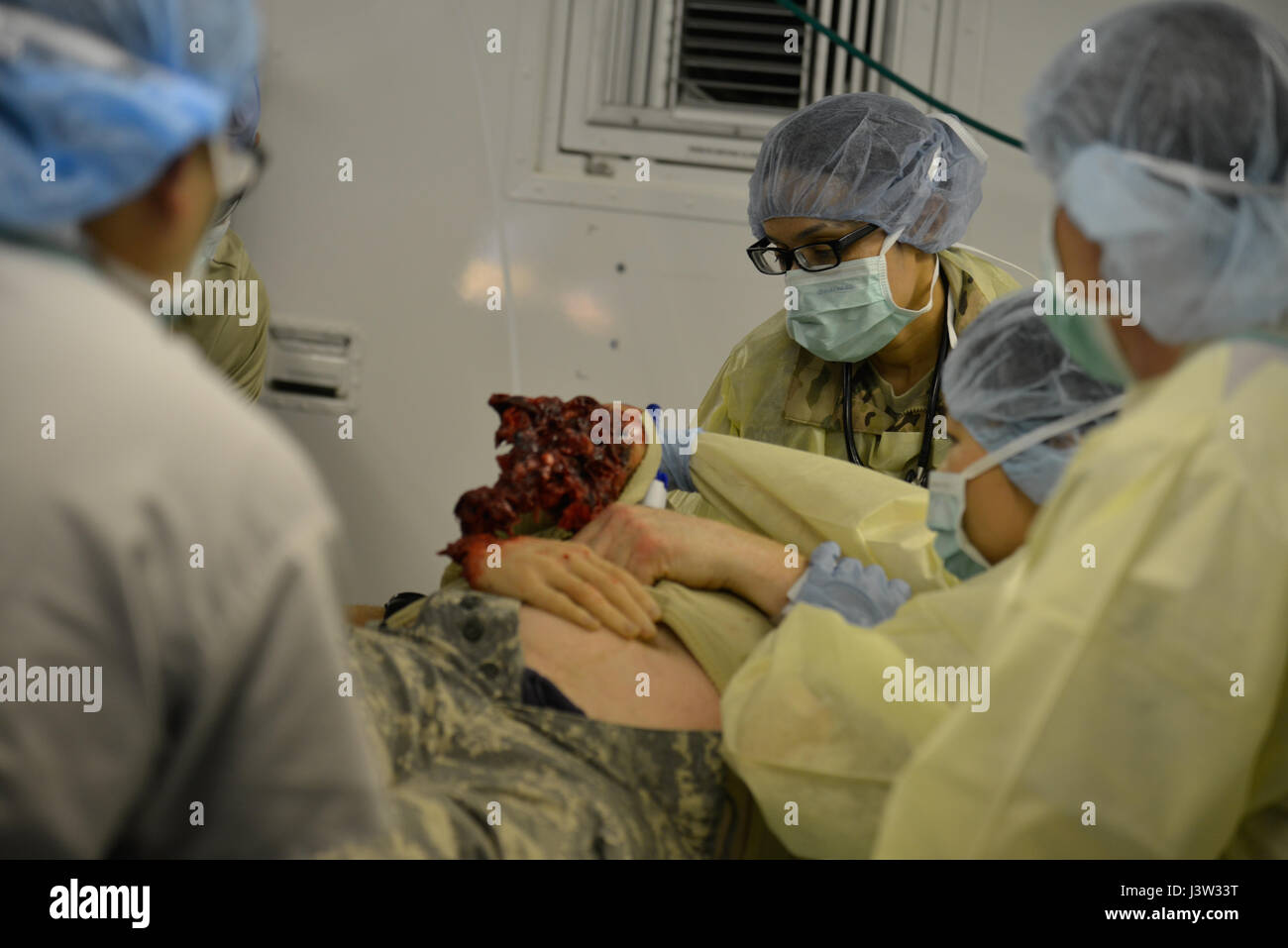 The 212th Combat Support Hospital (212th CSH) emergency room staff prepares to operate on a simulated casualty during triage at the 7th Army Training Command’s Hohenfels Training Area, April 27, 2017. The 212th CSH provides medical support for the 2nd Cavalry Regiment (2nd CR) during the multinational exercise Saber Junction 17. This exercise is the U.S. Army Europe’s 2nd CR’s combat training center certification exercise, designed to assess the readiness of the regiment to conduct unified land operations, with a particular emphasis on rehearsing the transition from garrison to combat operatio Stock Photo