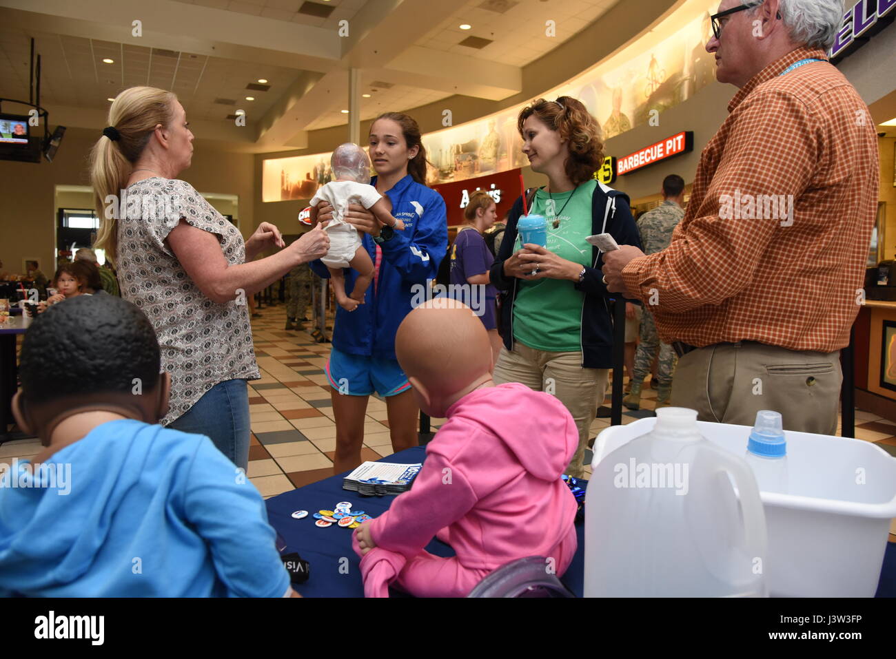 Paula Spooner, 81st Medical Operations Squadron family advocacy outreach manager, conducts a shaken baby syndrome simulation in the base exchange April 21, 2017, on Keesler Air Force Base, Miss. The family advocacy staff manned a booth with hand-outs and reading material about child abuse prevention for Keesler personnel in recognition of Child Abuse Prevention Month. (U.S. Air Force photo by Kemberly Groue) Stock Photo
