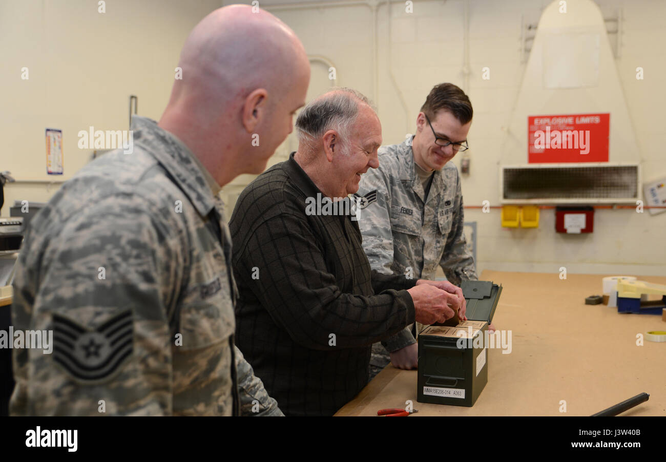 Carl Barnes (middle), 62nd Maintenance Squadron munitions flight chief, conducts an inspection on a carton of ammunition while Tech. Sgt. Christopher Groessler (left), 62nd MXS NCOIC stockpile management and Senior Airman Forrest Fender, 62nd MXS munitions inspector looks on at the munitions facility located on McChord Field, Wash., April 24, 2017. Barnes is retiring after 50 years of service and states that taking of people is one of the most important lessons all should live by. (U.S. Air Force photo/Senior Airman Jacob Jimenez) Stock Photo