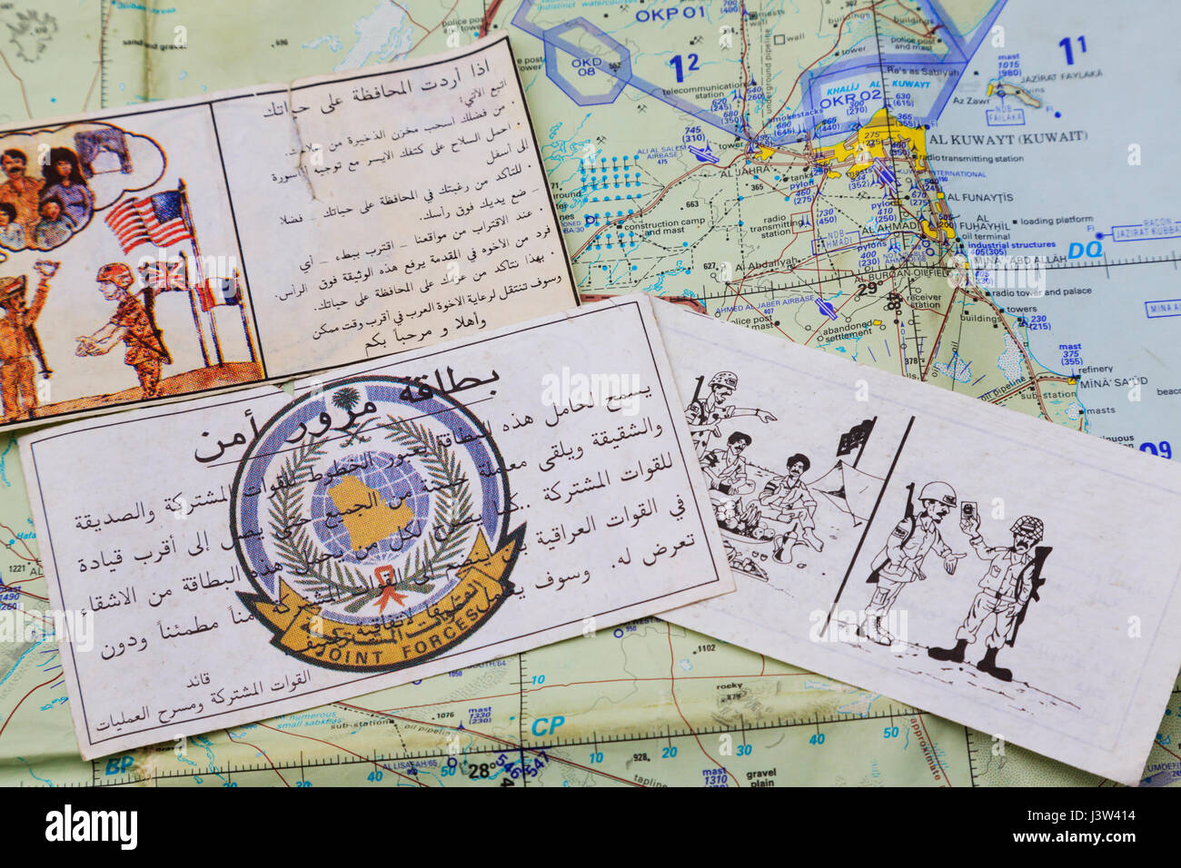 Psyops Leaflets encouraging Iraqi forces to surrender to Coallition forces during the Gulf War of 1990-1991, seen over an air map. Stock Photo