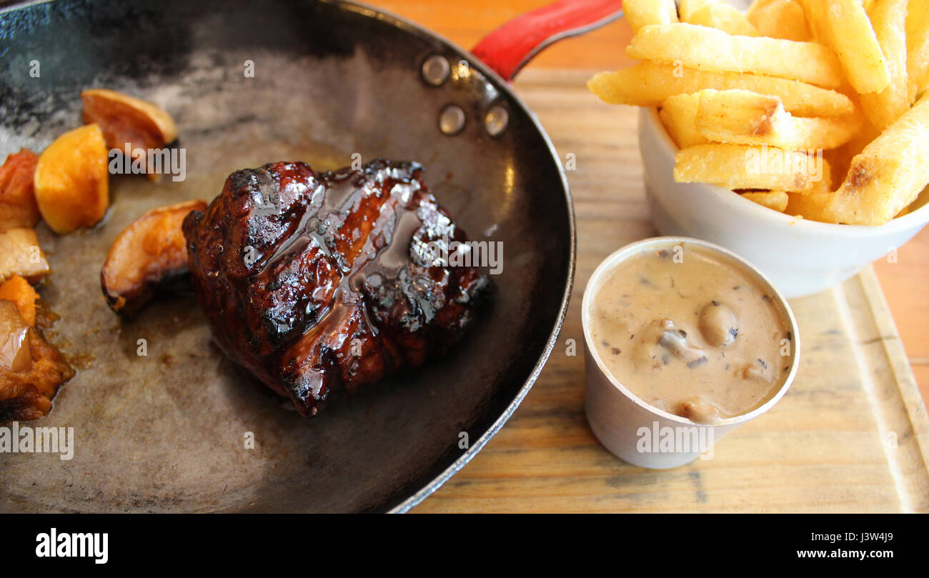 Beef fillet, chips and peppercorn sauce Stock Photo