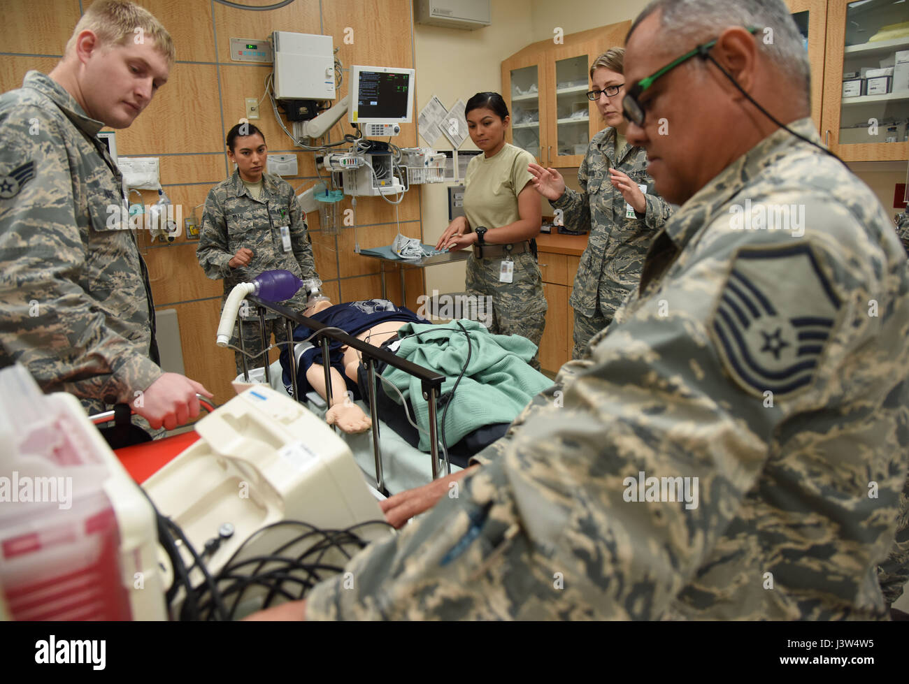 Members of the 81st Medical Operations Squadron simulate administering shock treatment to a “patient” during Code Blue Thursday in the Keesler Medical Center emergency room April 27, 2017, on Keesler Air Force Base, Miss. Emergency Room staff members coordinated with the simulation lab to use human patient simulators for running various advanced cardiac life support scenarios to improve Keesler’s new medical technicians’ skills and get them familiar with emergency equipment. (U.S. Air Force photo by Kemberly Groue) Stock Photo