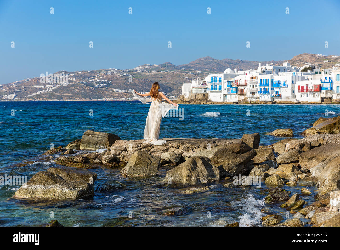 Young woman on the beach in white dress Stock Photo - Alamy