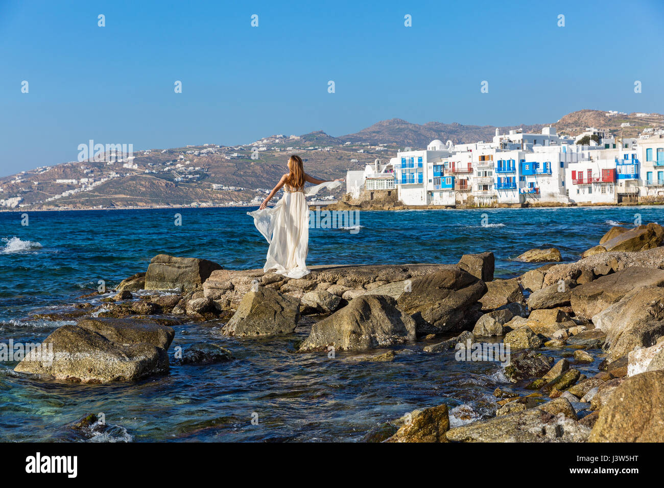 Young woman on the beach in white dress Stock Photo - Alamy