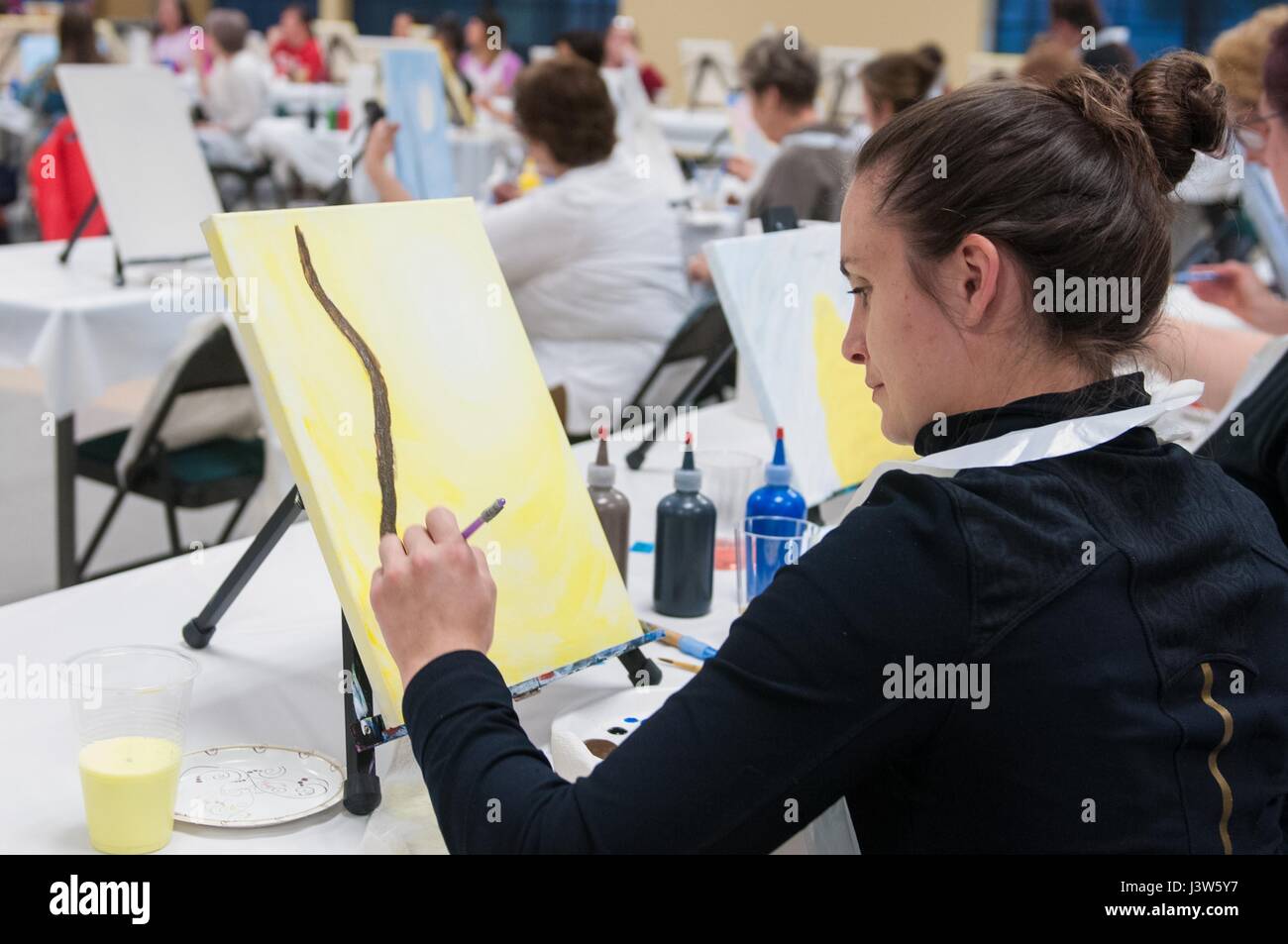 Callie Rogan paints a tree during a Wine and Canvas event on Joint Base ...