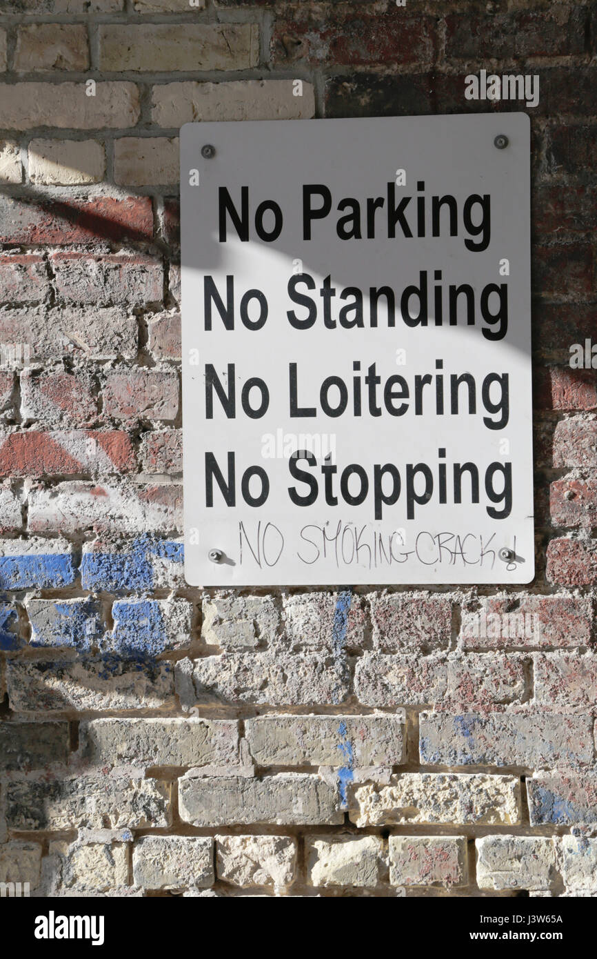 Sign stating No Parking No Standing No Loitering No Stopping and No Smoking Crack! Stock Photo