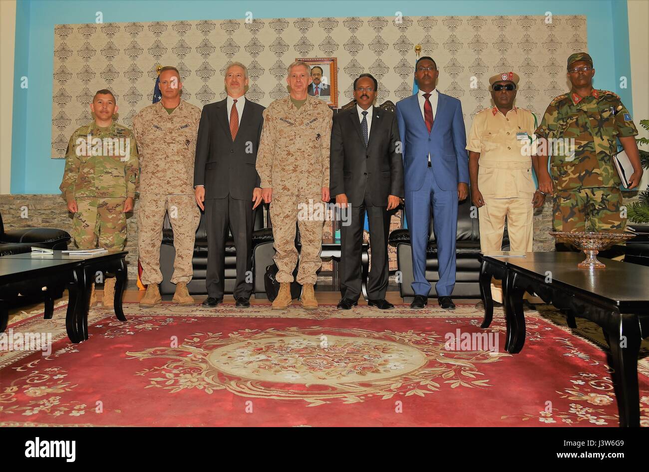 U.S. Africa Command commander U.S. Marine Corps Gen. Thomas D. Waldhauser, U.S. and President of Somalia Mohamed Abdullahi Mohamed, known by his nickname “Farmajo,” stand alongside their respective dignitaries and military coterie after their meeting held at Mogadishu International Airport, Somalia, April 29, 2017. With its partners, USAFRICOM works to neutralize transnational threats, protect U.S. personnel and facilities, prevent and mitigate conflict, and build defense capability to promote regional stability and prosperity. (U.S. Air National Guard photo by Tech. Sgt. Andria Allmond) Stock Photo