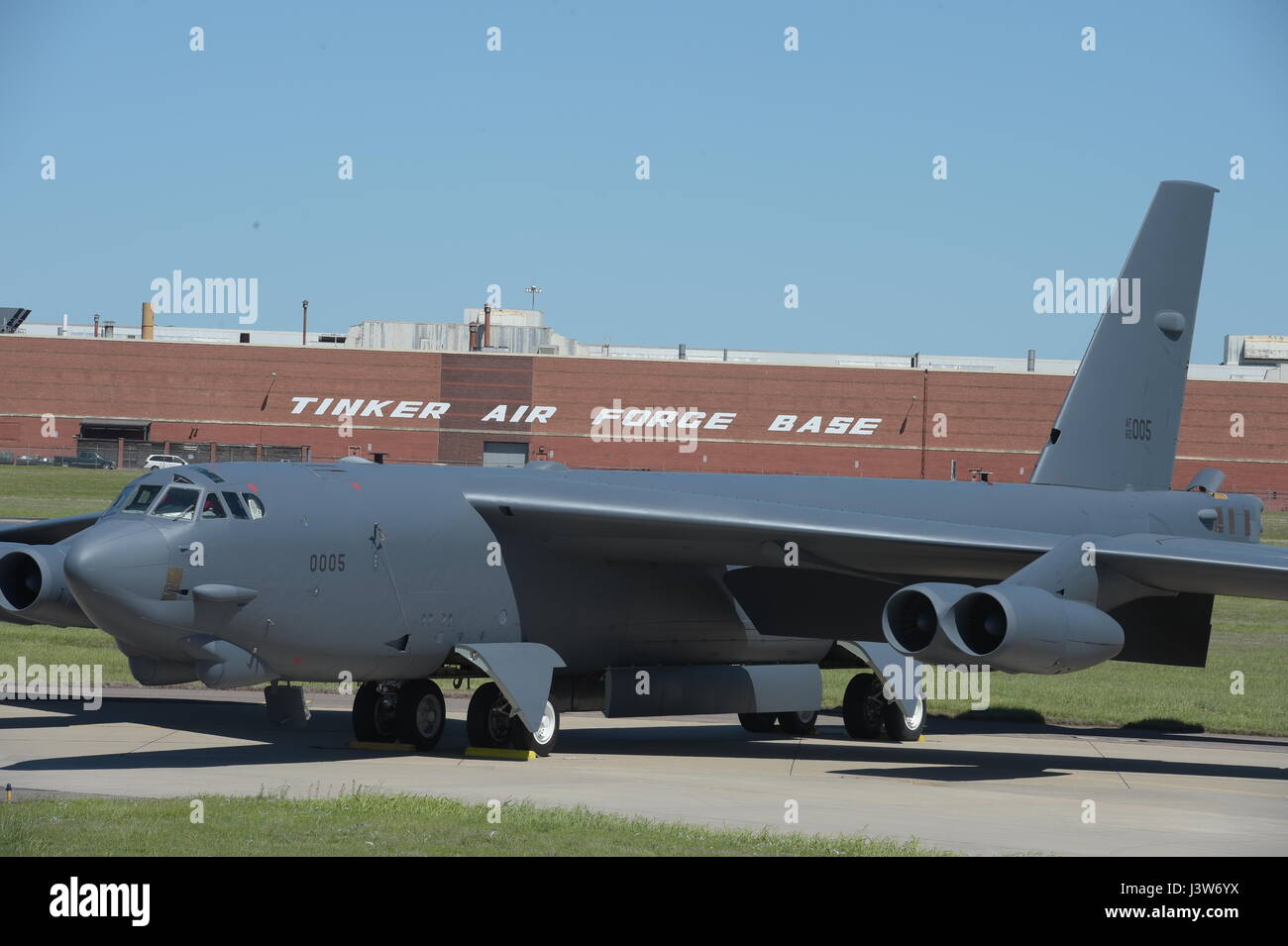 Boeing B-52H, 60-0005, poses in front of Oklahoma City Air Logistics Complex Bldg. 3001 following major overhaul on May 1, 2017, Tinker Air Force Base, Oklahoma. OC-ALC is responsible for depot level maintenance of the B-52 fleet with a large portion of the work taking place in the building shown behind. (U.S. Air Force photo/Greg L. Davis) Stock Photo