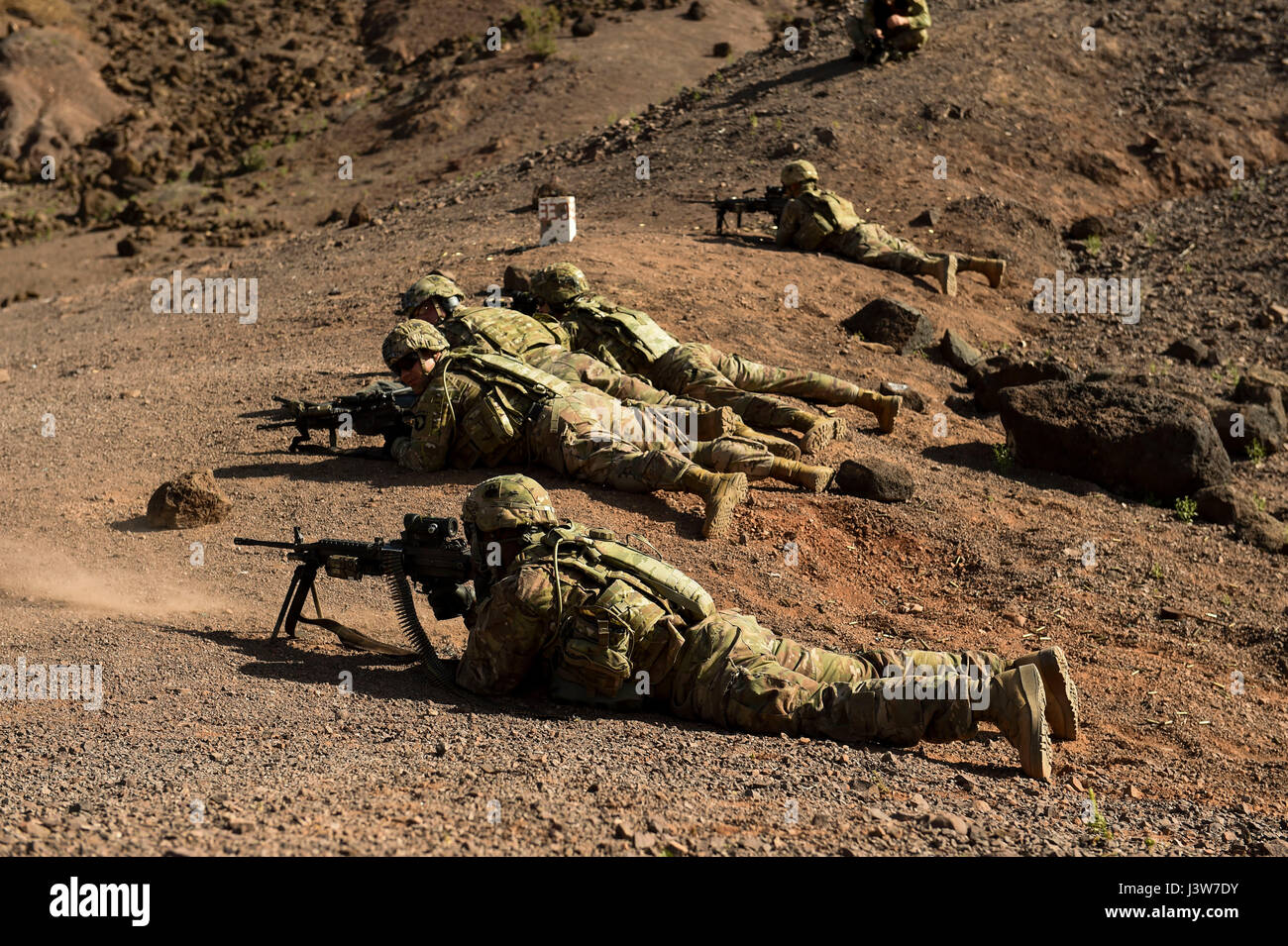 U.S. Army soldiers with 2nd Platoon, Bravo Company, 1-327 Infantry, 1st Brigade Combat Team, 101st Airborne Division (Air Assault) assigned to Combined Joint Task Force-Horn of Africa's (CJTF-HOA) East African Response Force, provide suppressing fire during a small arms training range at Arta, Djibouti, May 2, 2017. Through unified action with U.S. and international partners in East Africa, CJTF-HOA conducts security force assistance, executes military engagement, provides force protection, and provides military support to regional counter-violent extremist organization operations in order to Stock Photo