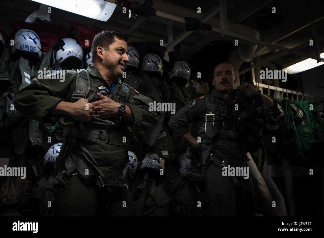 170503-N-MJ135-329  PACIFIC OCEAN (May 3, 2017) Cmdr. Ladislao Montero, left, executive officer of the 'Cougars' of Electronic Attack Strike Squadron (VAQ) 139, and Lt. Cmdr. Kyle Vandrgriff prepare for flight operations aboard the aircraft carrier USS Theodore Roosevelt (CVN 71) during a group sail training unit exercise. The exercise is the first step in the ship's integrated training phase and aims to enhance mission-readiness and warfighting capabilities between the ship, airwing and the staff through simulated real-world scenarios. (U.S. Navy Photo by Mass Communication Specialist 3rd Cla Stock Photo