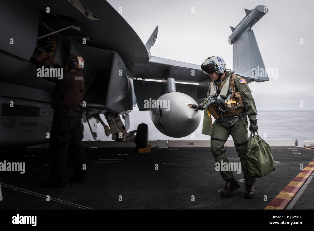 170503-N-MJ135-443  PACIFIC OCEAN (May 3, 2017) Cmdr. Ladislao Montero, executive officer of the 'Cougars' of Electronic Attack Strike Squadron (VAQ) 139, performs his pre-flight inspections on an EA-18G Growler aboard the aircraft carrier USS Theodore Roosevelt (CVN 71) during a group sail training unit exercise. The exercise is the first step in the ship's integrated training phase and aims to enhance mission-readiness and warfighting capabilities between the ship, airwing and the staff through simulated real-world scenarios. (U.S. Navy Photo by Mass Communication Specialist 3rd Class Spence Stock Photo