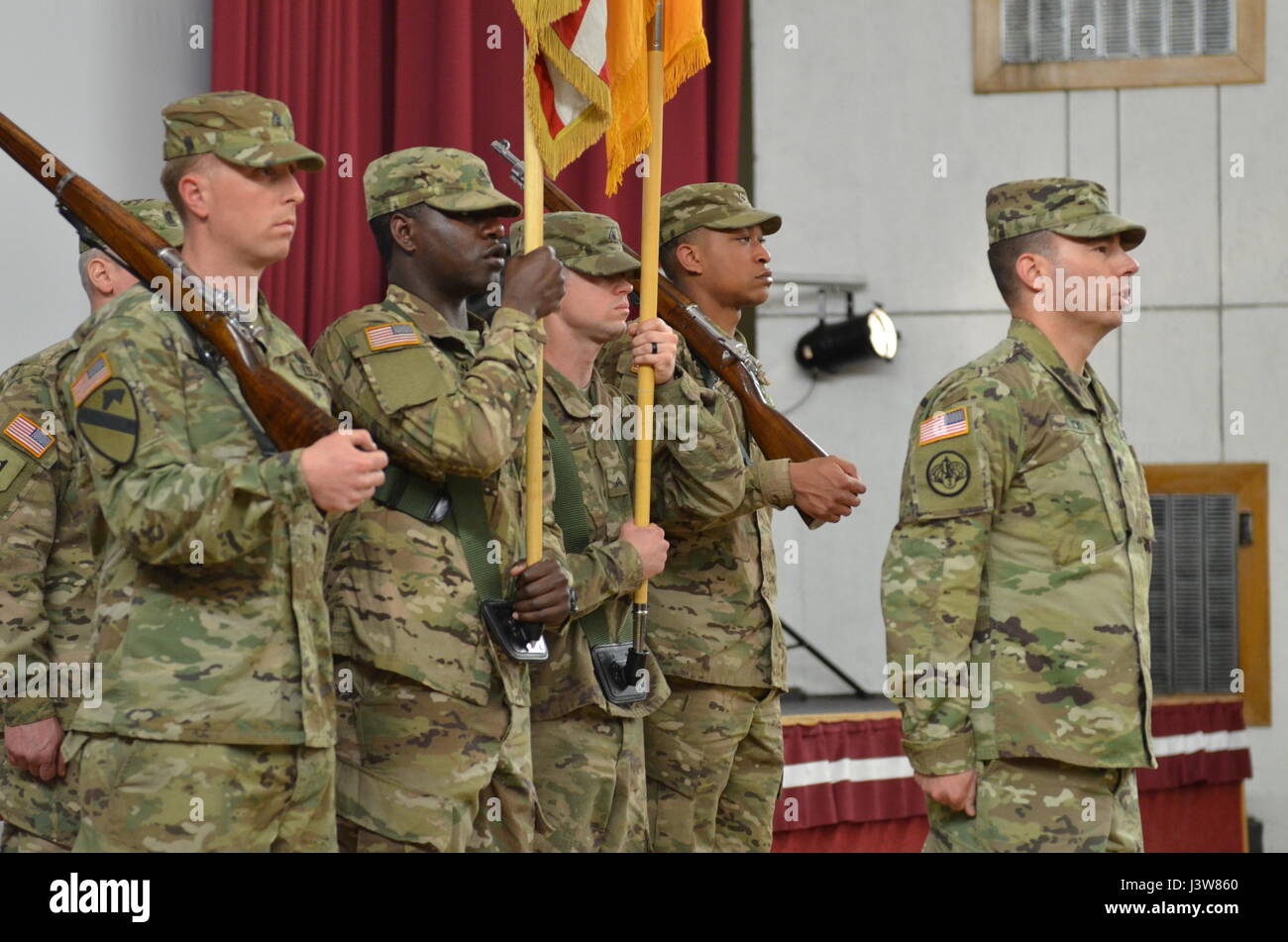 ADAZI, Latvia — Lt. Col. Jonathan S. Kluck, the new battalion commander of 1st Battalion, 68th Armor Regiment, 3rd Armored Brigade Combat Team, 4th Infantry Division, Fort Carson, Colorado, leads his new unit in the 4th Inf. Div. song and the Army song during the change of command ceremony in the theater at Adazi Military Base, Latvia, May 4, 2017.  The unit is deployed into Europe for Operation Atlantic Resolve,  a U.S. -led endeavor to fulfill the U.S. commitment to NATO by rotating throughout Europe and training alongside NATO Allies and partners. (Sgt. Shiloh Capers) Stock Photo