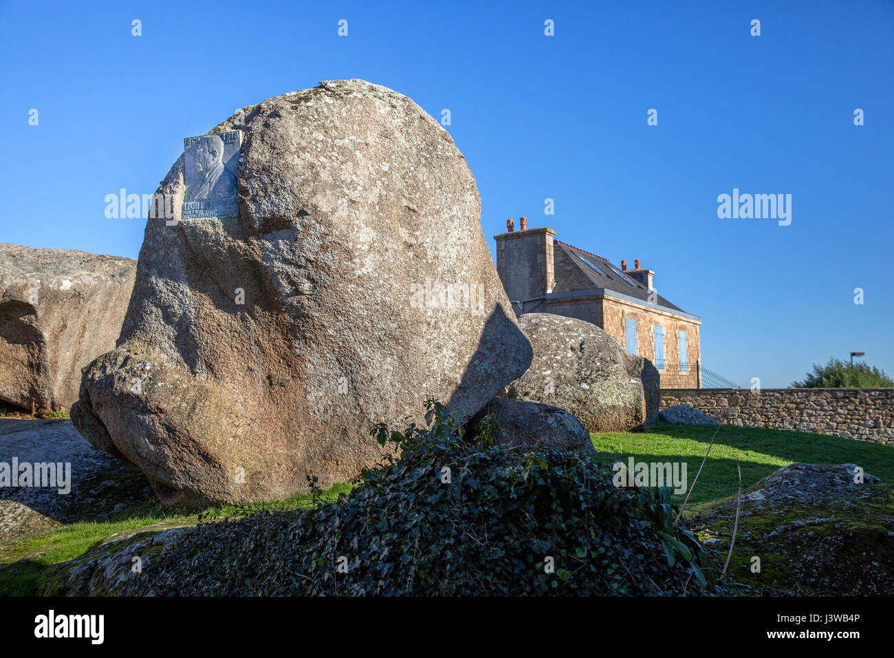 Plaque and boulder monument dedicated to French poet and songwriter Leon Durocher in Tregastel, Brittany, France - Louis H. Nicot/1937 Stock Photo