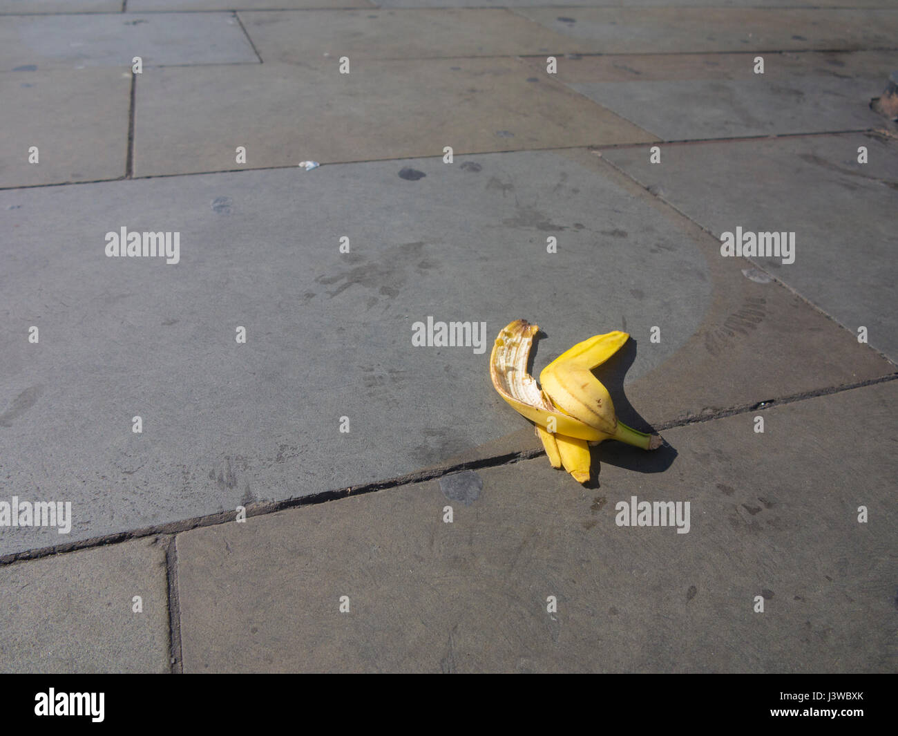 A discarded banana skin ready to trip someone over or slip on Stock Photo
