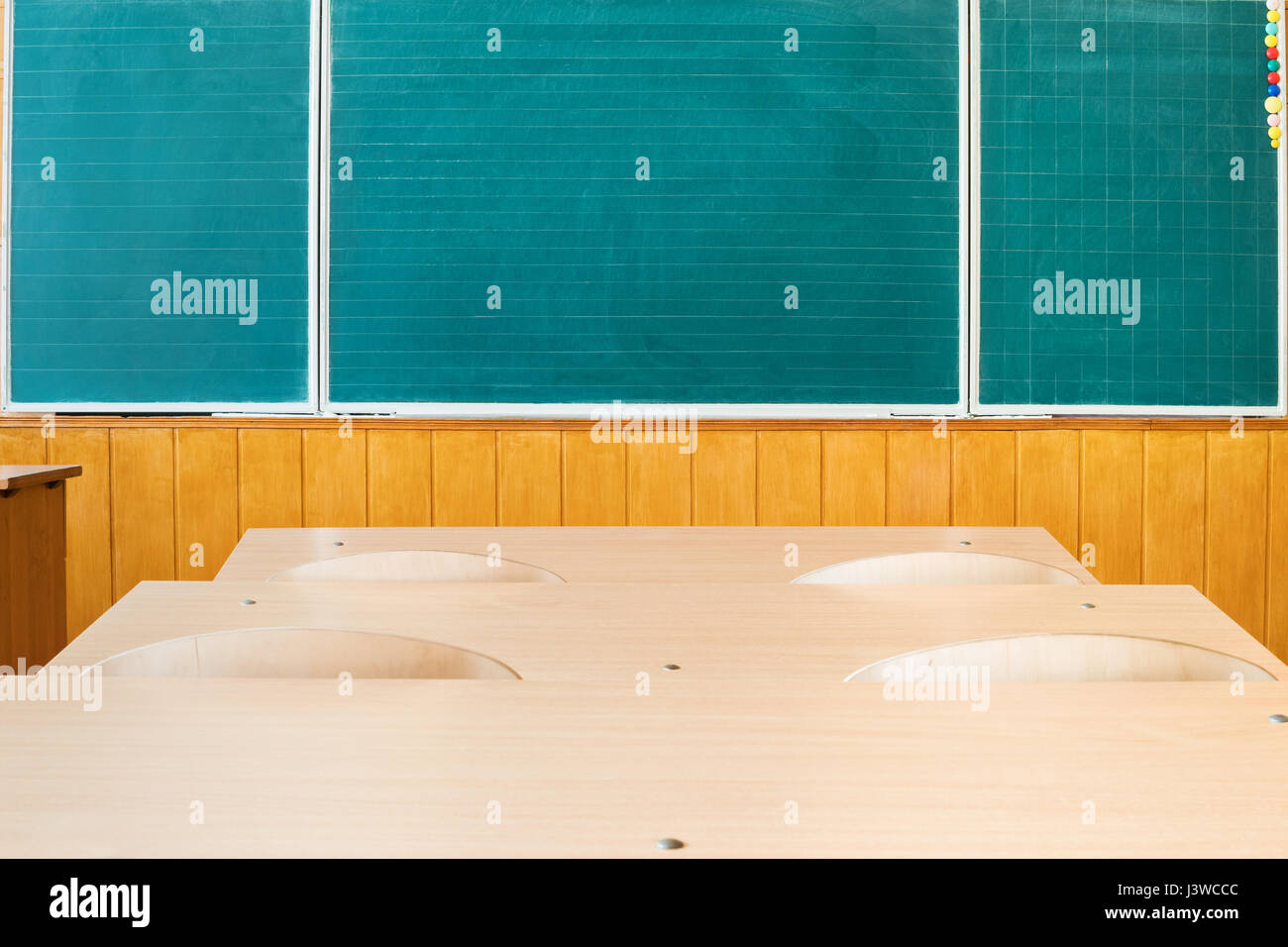 Wooden desks and chalkboard in empty classroom school Stock Photo - Alamy