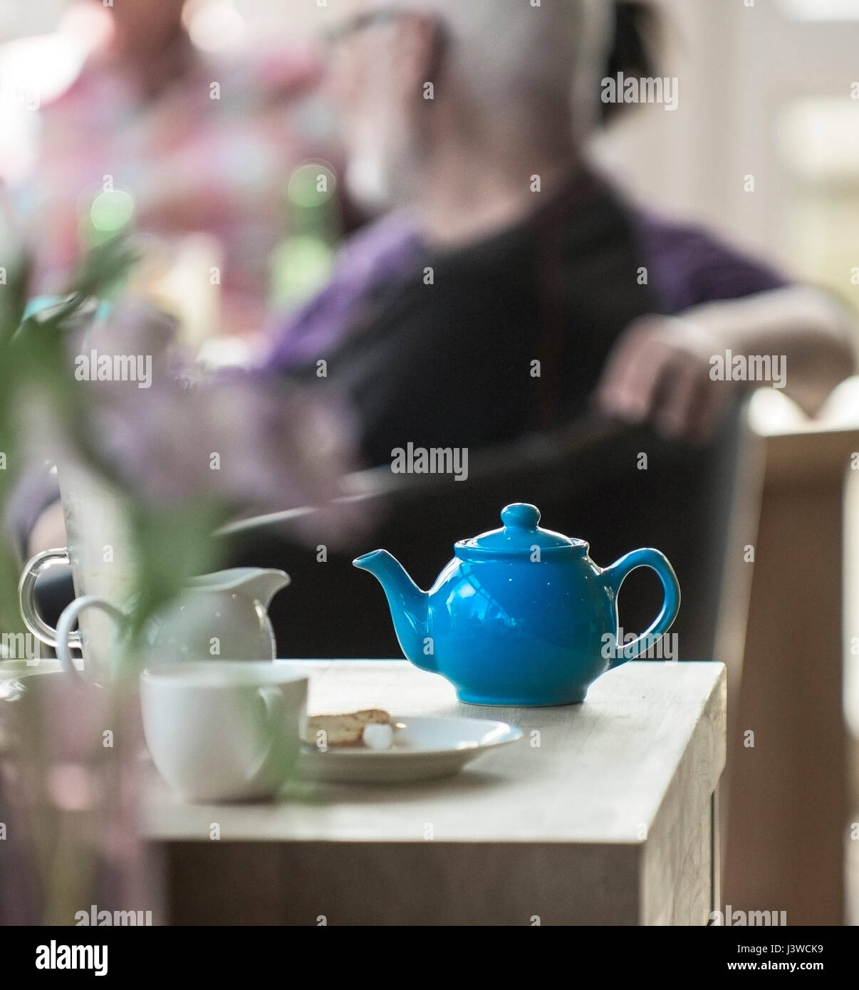 A blue teapot on a table restaurant Cafe Cafeteria Afternoon tea Stock Photo