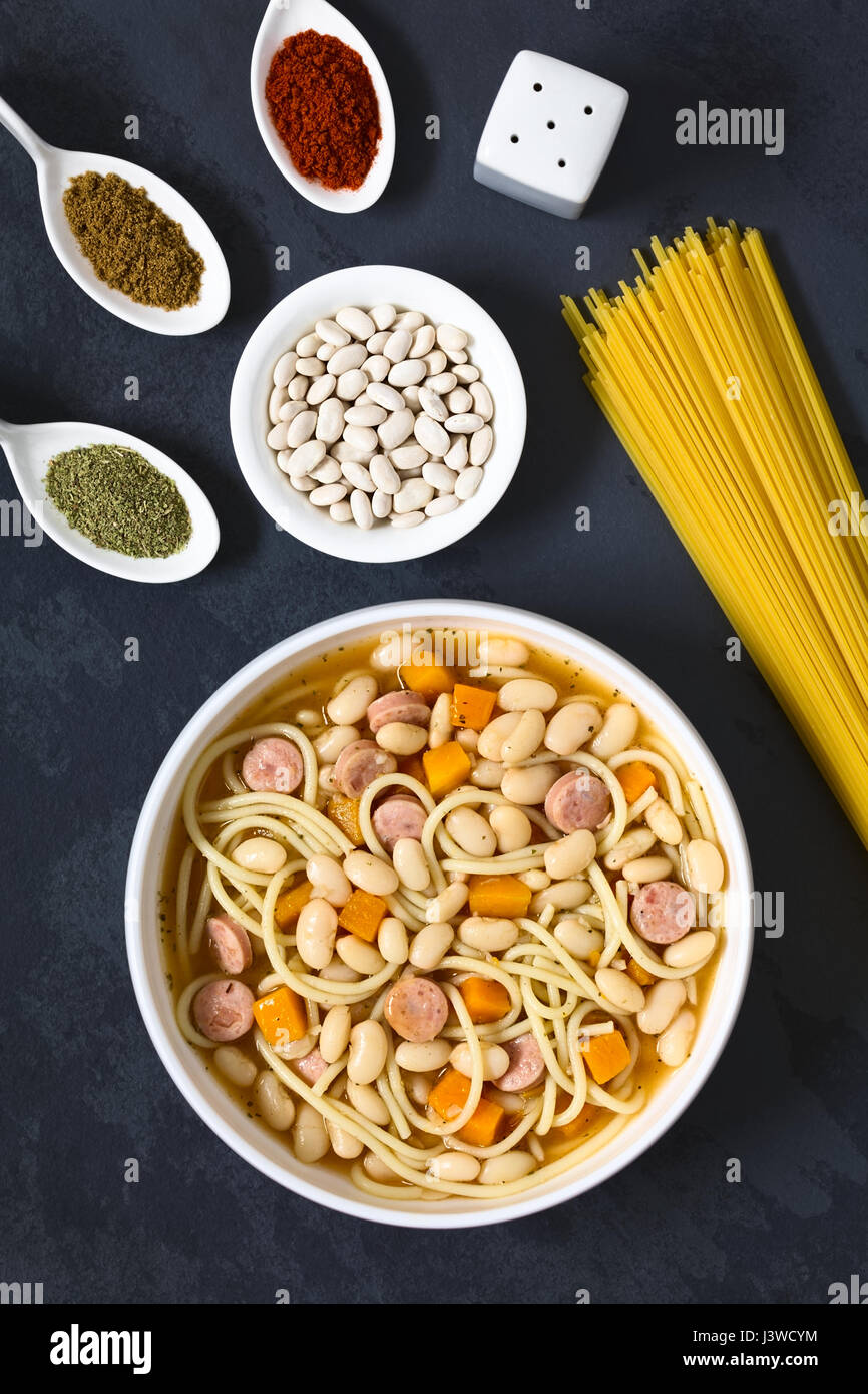 Chilean traditional Porotos con Riendas (beans with reins) dish of cooked dried beans with pumpkin, onion, spaghetti, sausage Stock Photo