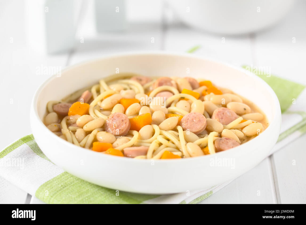 Chilean traditional Porotos con Riendas (beans with reins) dish of cooked dried beans with pumpkin, onion, spaghetti and sausage Stock Photo