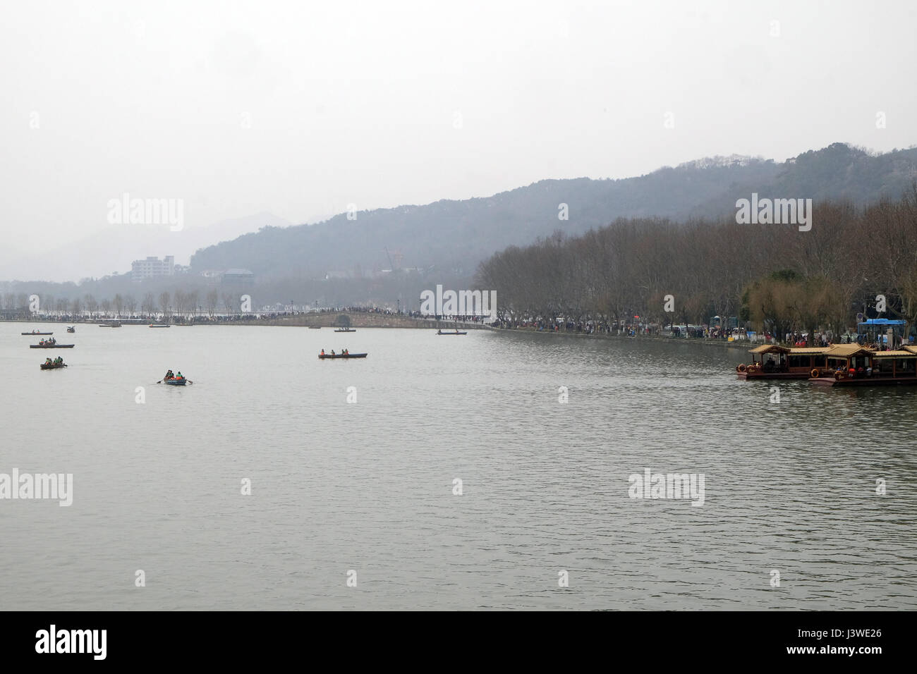 People are moving in boats on West lake in Hangzhou, China, February 21, 2016. Stock Photo