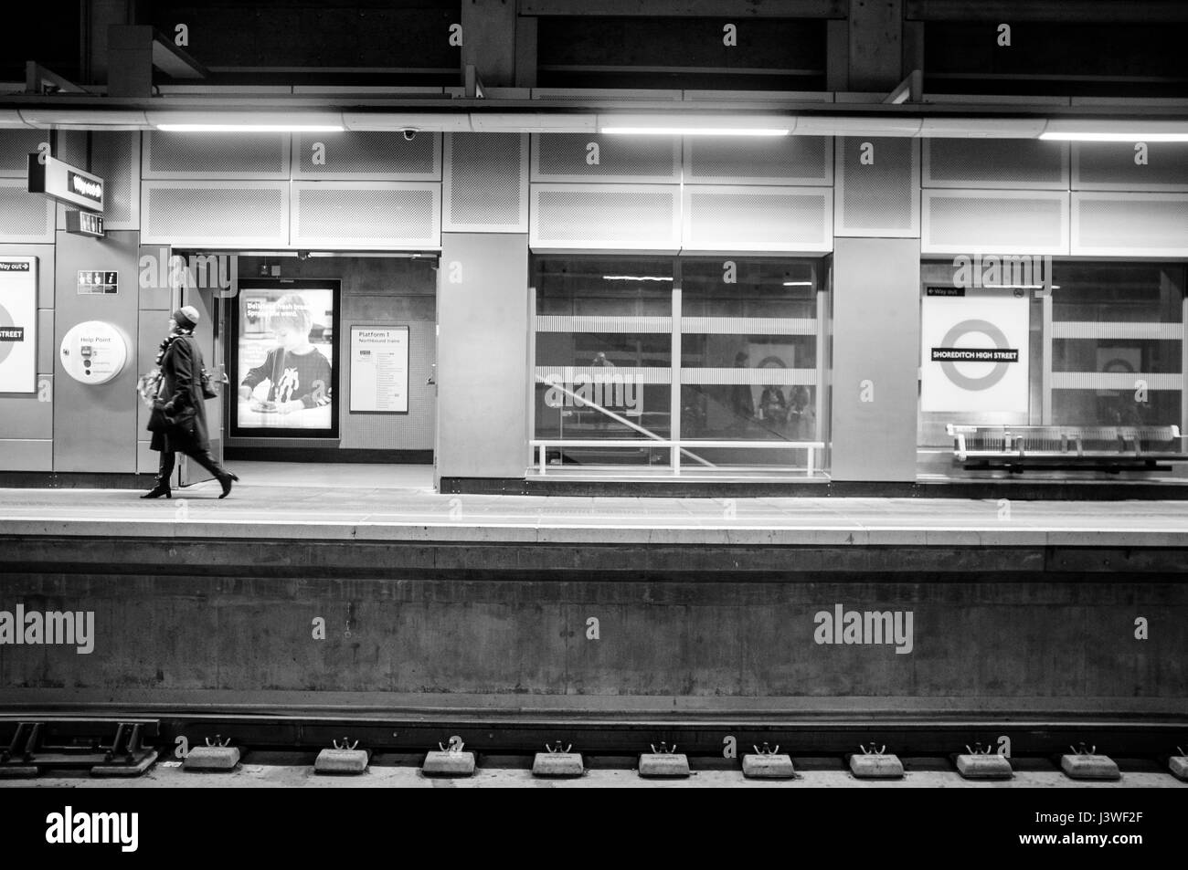 Woman walking on platform at Shoreditch High Street, London. Stock Photo
