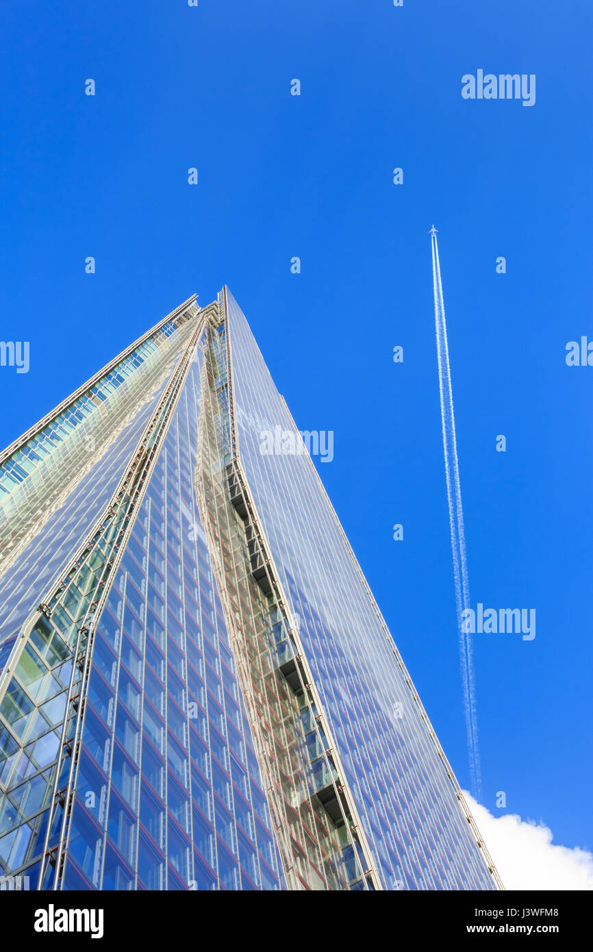 The Shard skyscraper from below with a plane going past, London Bridge, London Stock Photo