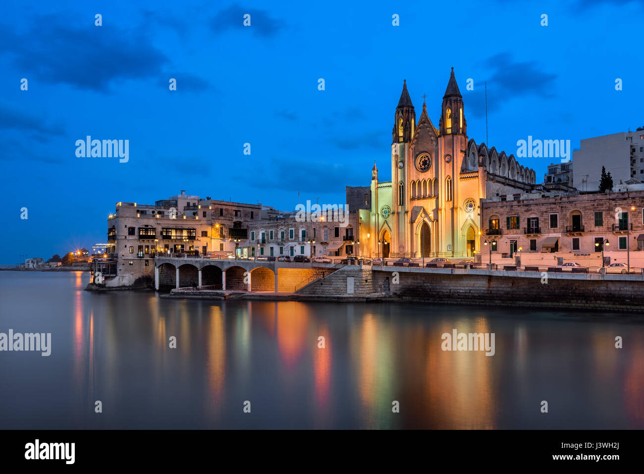 Balluta Bay and Church of Our Lady of Mount Carmel in the Evening, Saint Julien, Malta Stock Photo