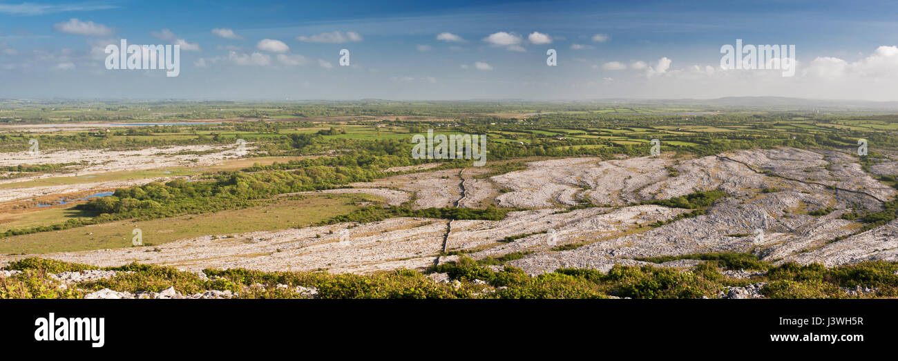 Panoramic view east and south over the limestone pavement karst landscape of the Burren towards south Clare, from Mullaghmore, County Clare, Ireland Stock Photo