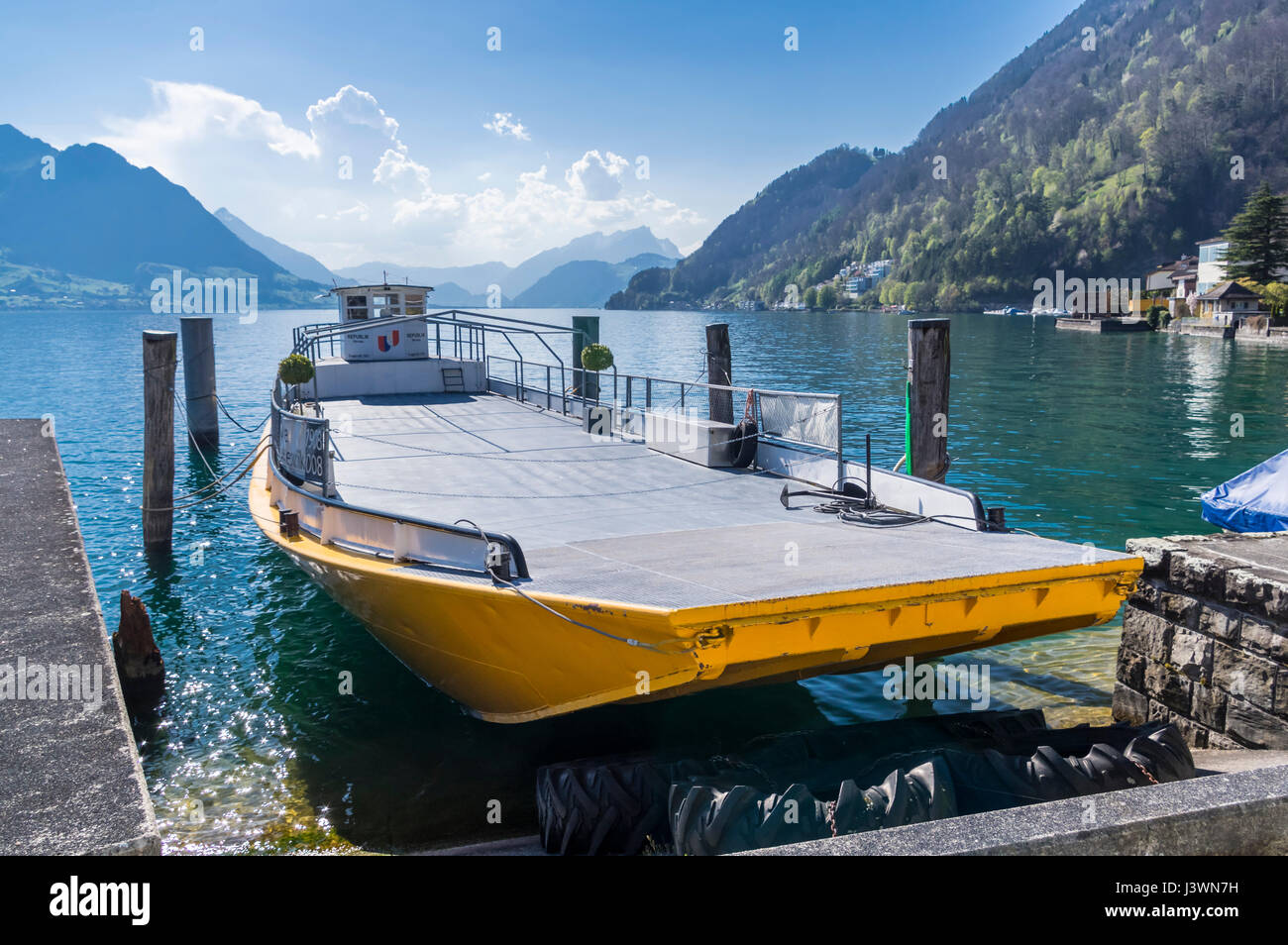 Self-propelled barge 'Republik', built in 1908, mooring in Gersau, Switzerland. This type of flat-bottomed boats is locally referred to as 'Nauen'. Stock Photo