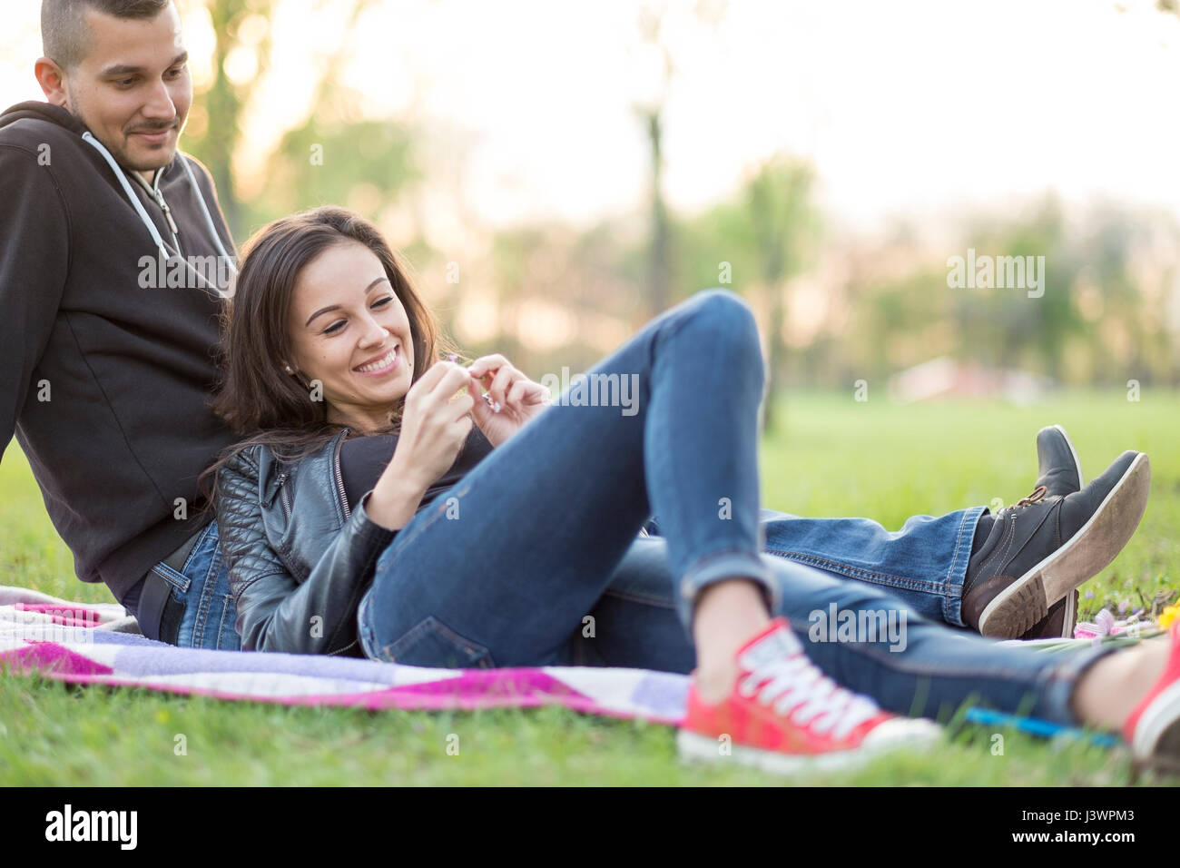 Romantic couple date love in park at sunset Stock Photo - Alamy