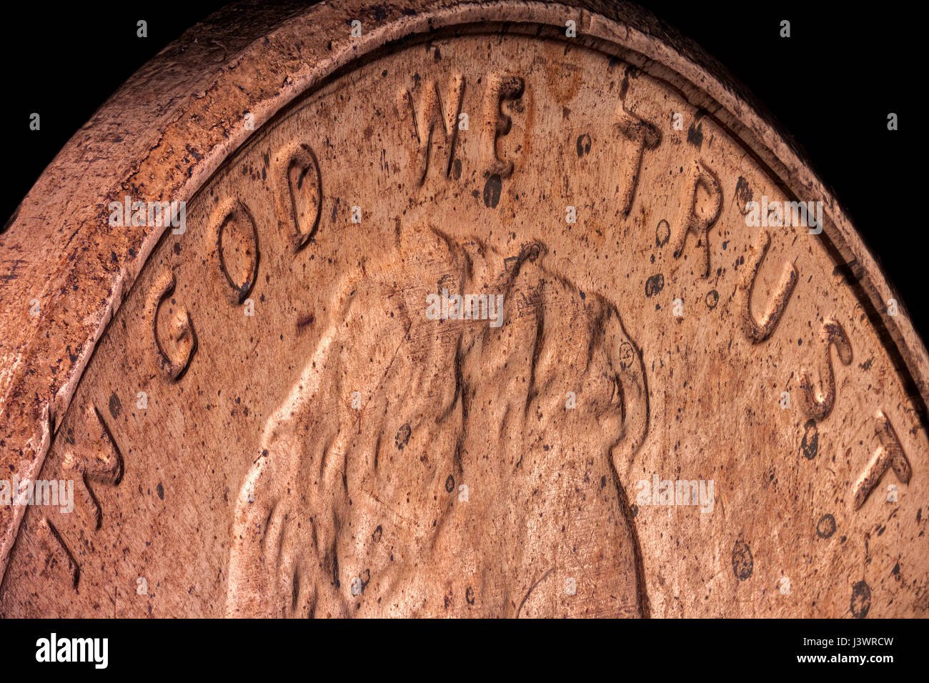 Extreme macro, sharp and detailed, of an American copper penny, emphasizing the official motto of the United States: In God We Trust Stock Photo