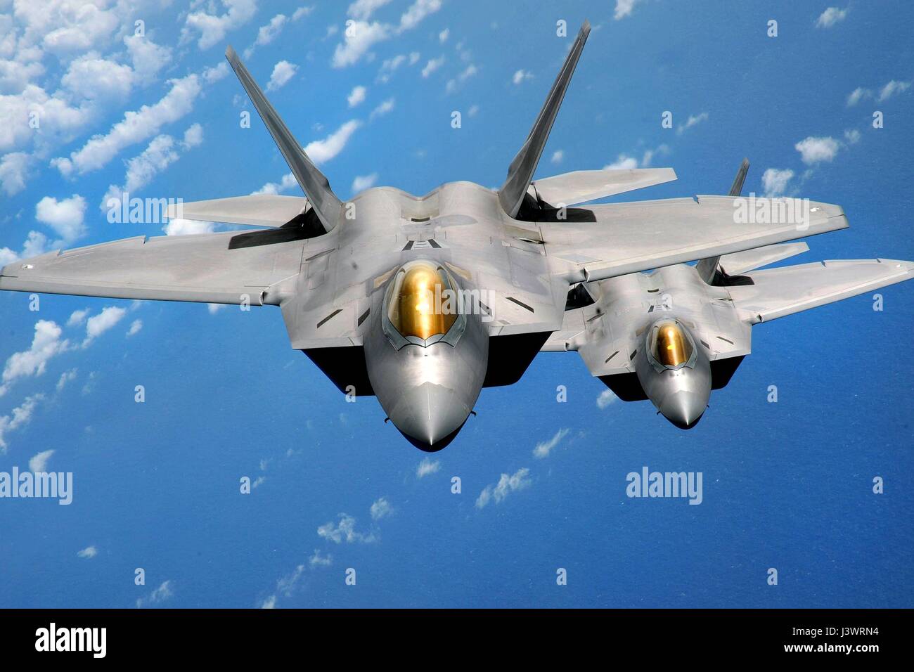 Two USAF F-22 Raptor stealth tactical fighter aircraft fly in formation over the Anderson Air Force Base March 3, 2009 in Yigo, Guam.    (photo by Kevin J. Gruenwald/US Air Force  via Planetpix) Stock Photo