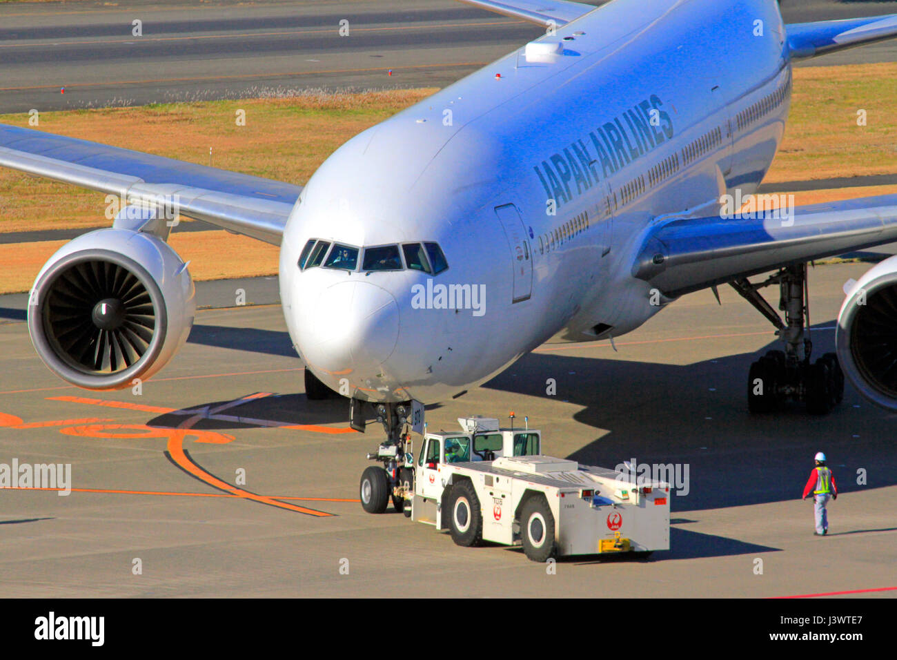 JAL Boeing 777 Pushed by Towing Car at Haneda Airport Tokyo Japan Stock Photo