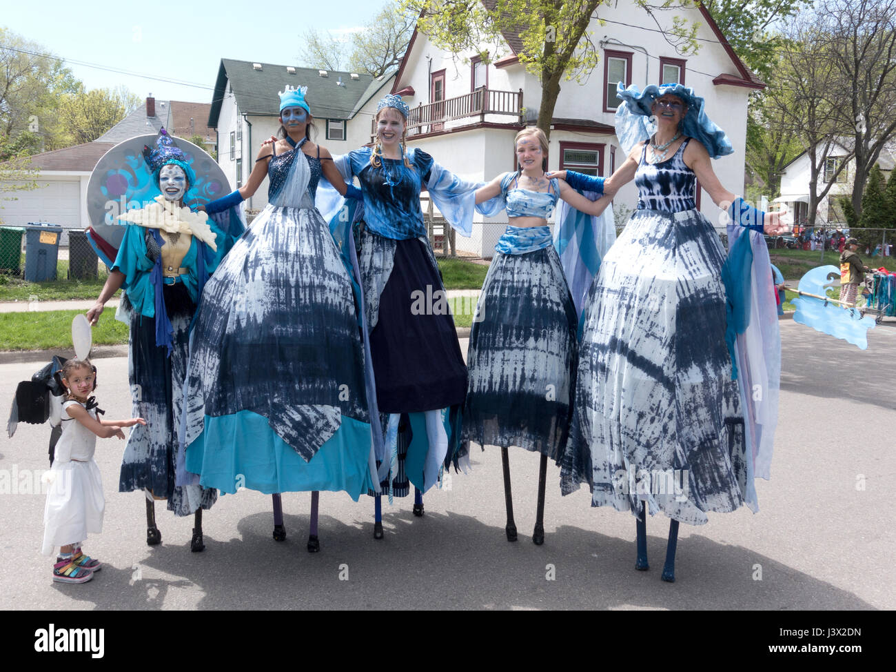 Minneapolis, Minnesota, USA. 7th May, 2017. Group of women on stilts dressed in costume dresses