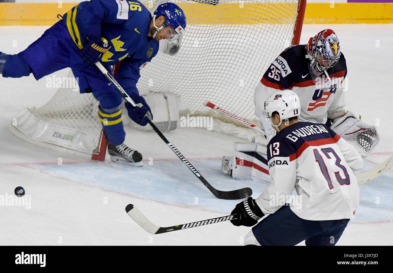 Sweden's Marcus Krueger (L) tries to score against US goalkeeper Jimmy Howard and player Johnny Gaudreau during the match between the USA and Sweden at the Ice Hockey World Championships at the Lanxess Arena in Cologne, Germany, 8 May 2017. Photo: Monika Skolimowska/dpa Stock Photo