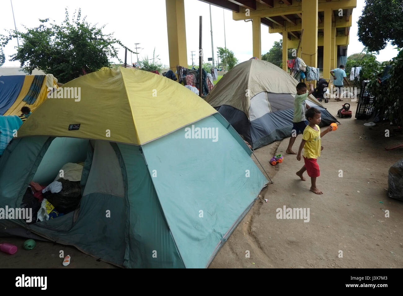 Manaus, 05/08/2017 - AM - Approximately 30 Warao families from Venezuela camped under the flower viaduct near the Manaus bus station in the Central-South region, most of them live in handicrafts, but what attracts attention is which half are children and teenagers. The Warao Indians have fled to Brazil since 2014, when the political and economic crisis in Venezuela worsened, causing lack of food, personal hygiene, medicines, medical care and energy for the population. (Photo: Danilo Mello) Stock Photo