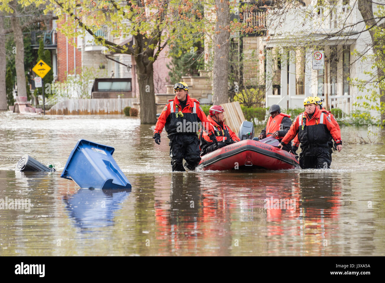 Montreal, Canada. 8th May, 2017. Firemen use an inflatable boat to help residents as flooding hits Cousineau street Credit: Marc Bruxelle/Alamy Live News Stock Photo