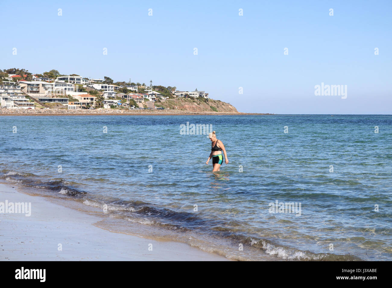 Adelaide Australia. 9th May 2017. A woman swims  in the   on a day of clear blue skies and autumn sunshine on the beach at the coastal suburb of Brighton as temperatures stay mild during the Autumn season in Adelaide Credit: amer ghazzal/Alamy Live News Stock Photo